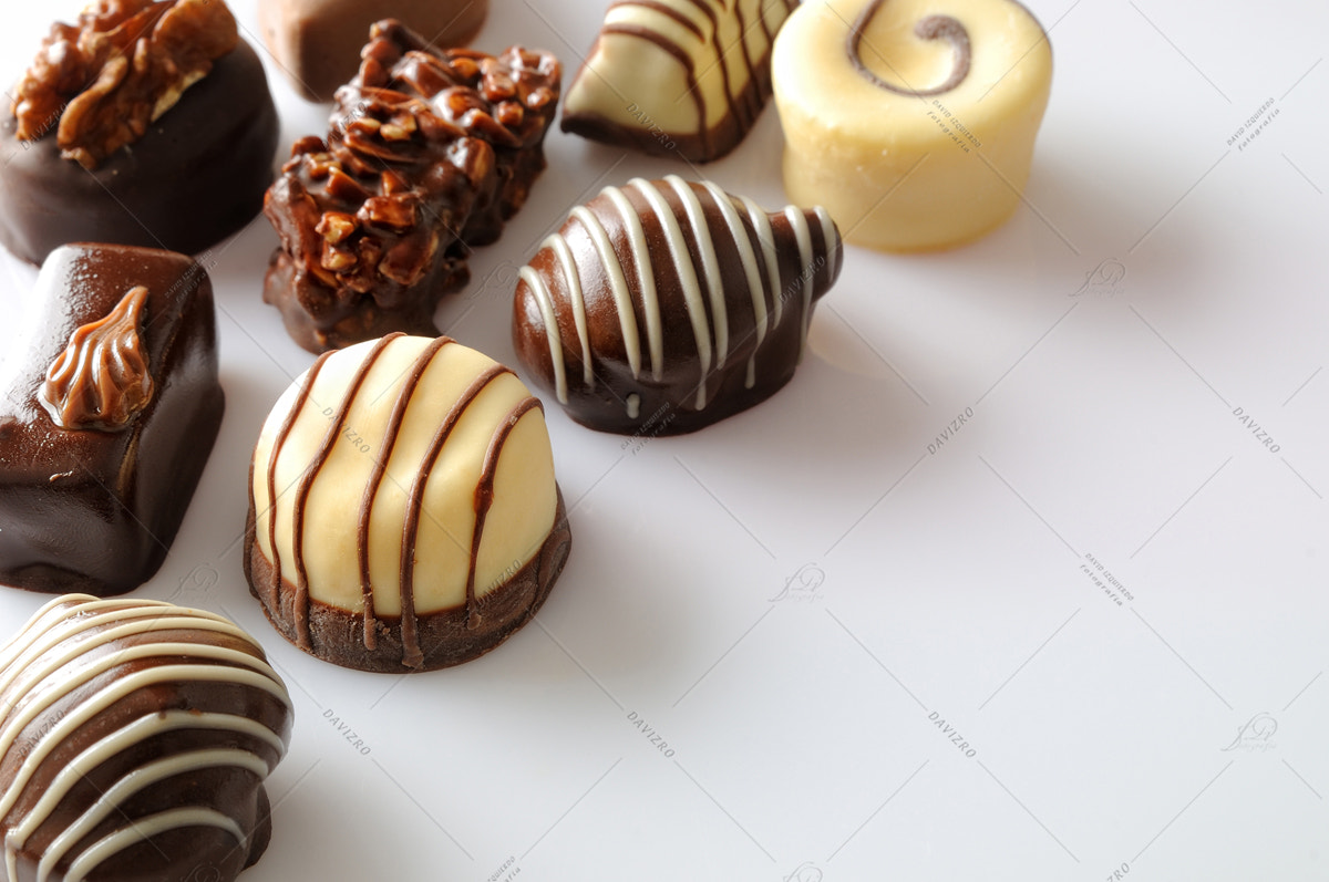 Nikon D300 sample photo. Assorted bonbons on a white table top diagonal aligned photography