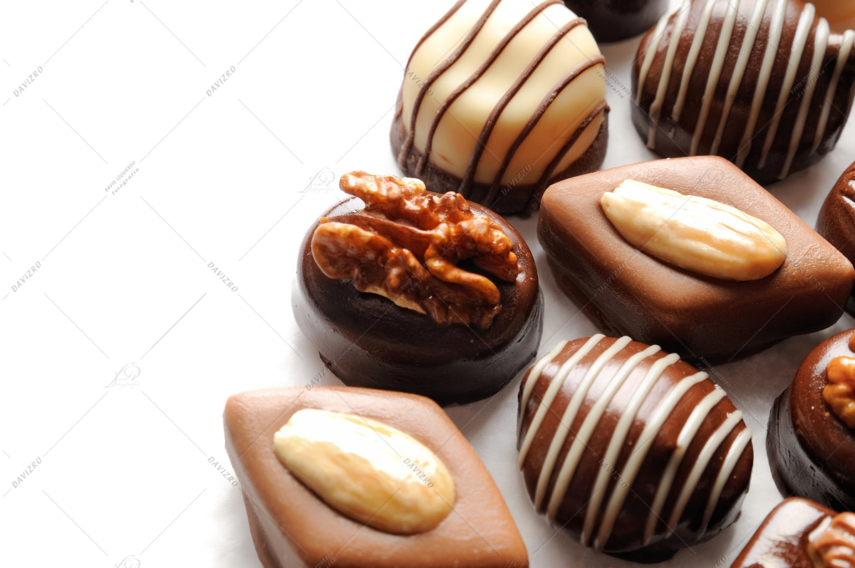 Nikon D300 sample photo. Assorted bonbons on a white table top view close up photography