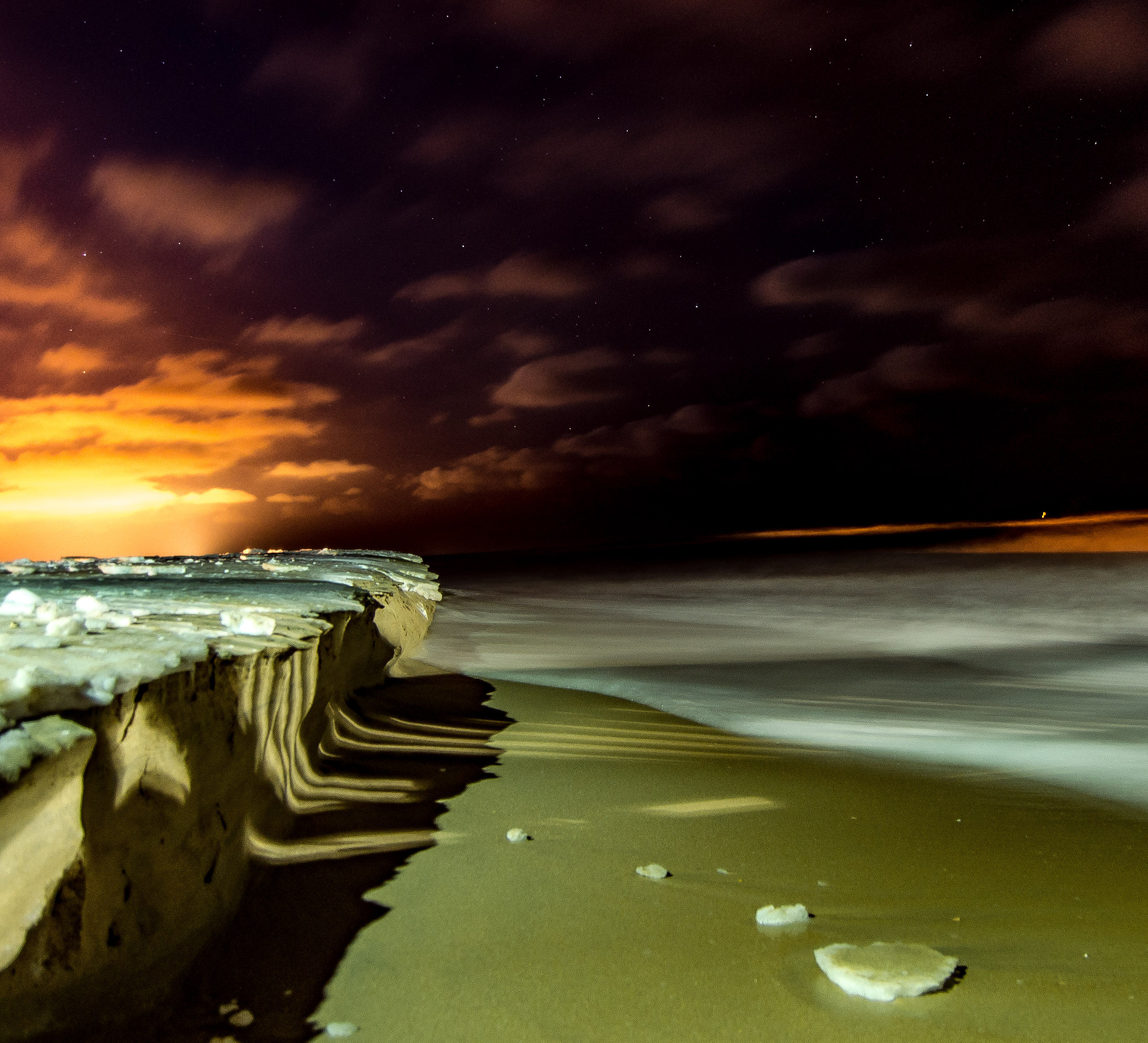 Nikon D600 sample photo. Ice on the beaches of virginia, with the lights of the city in the distance. photography