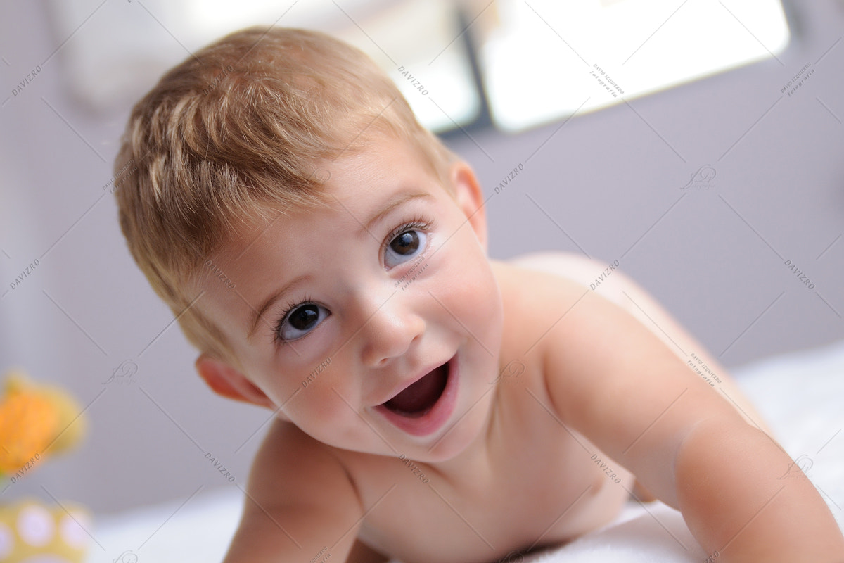 Tamron SP 24-70mm F2.8 Di VC USD sample photo. Cheerful blond baby on a bed photography