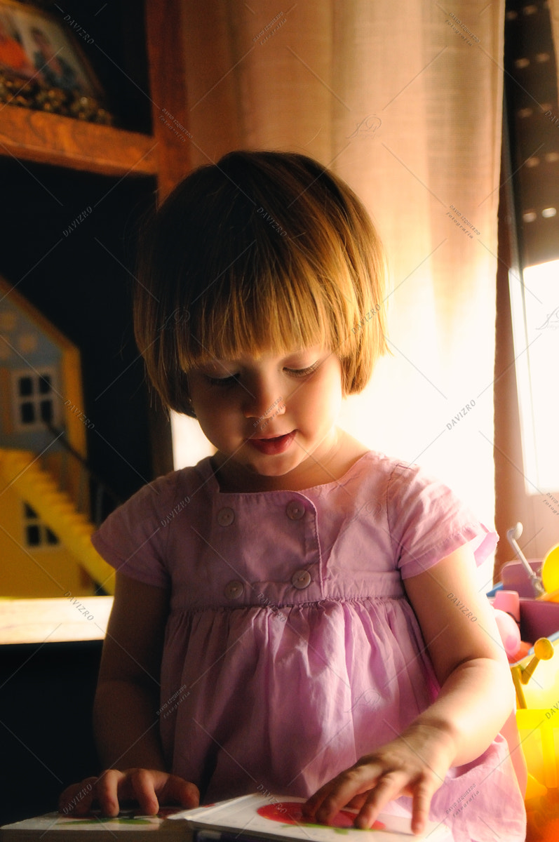 Tamron SP 24-70mm F2.8 Di VC USD sample photo. Little girl watching an educational book on a table in a room photography