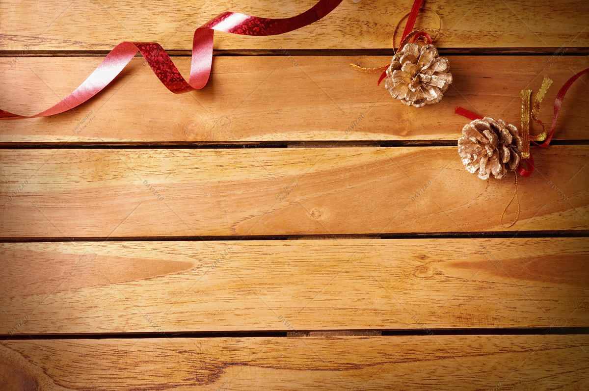 Nikon D300 sample photo. Red ribbon and pinecone christmas decoration on wooden table top photography
