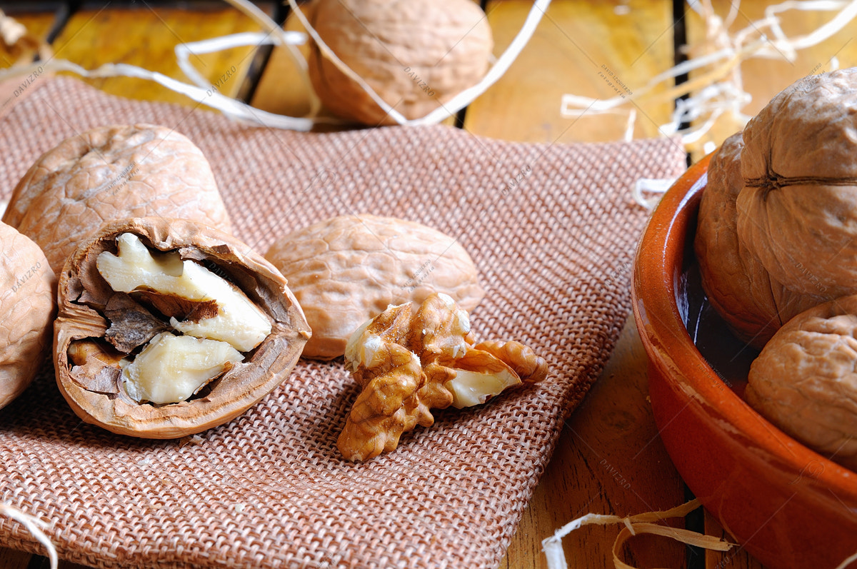 Tamron SP 24-70mm F2.8 Di VC USD sample photo. Group of healthy walnuts on a wooden table photography