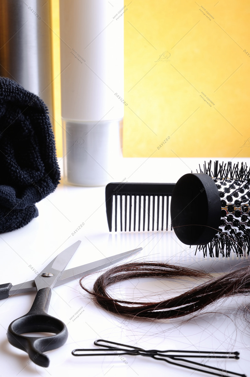 Set hairdressing articles on glass table vertical composition