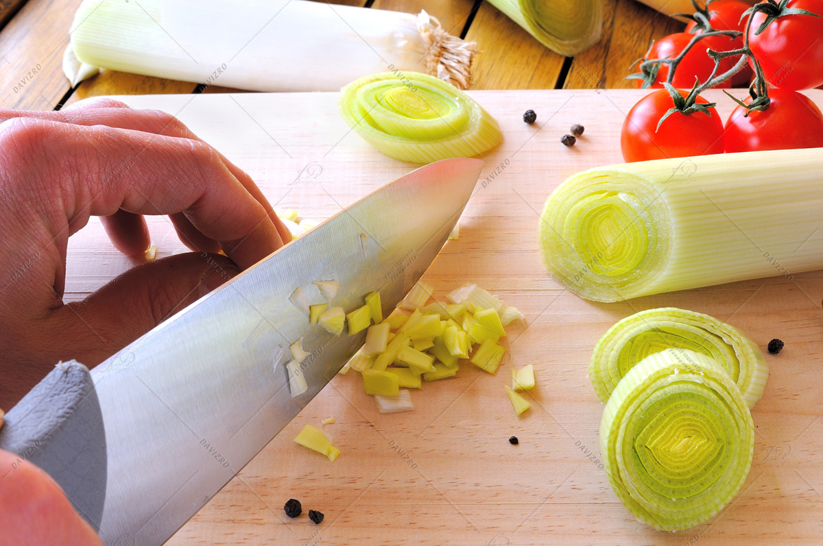 Tamron SP 24-70mm F2.8 Di VC USD sample photo. Chef cutting a leek on cutting board photography