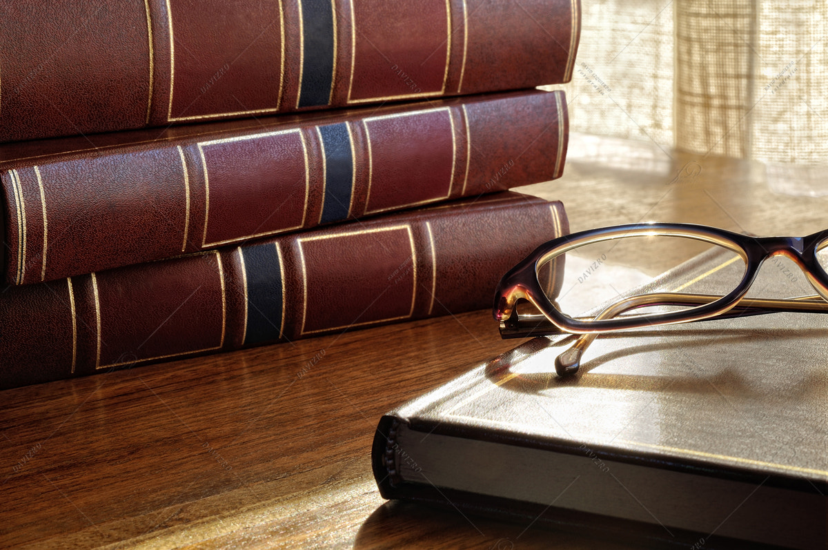 books on the table and glasses and the bottom window