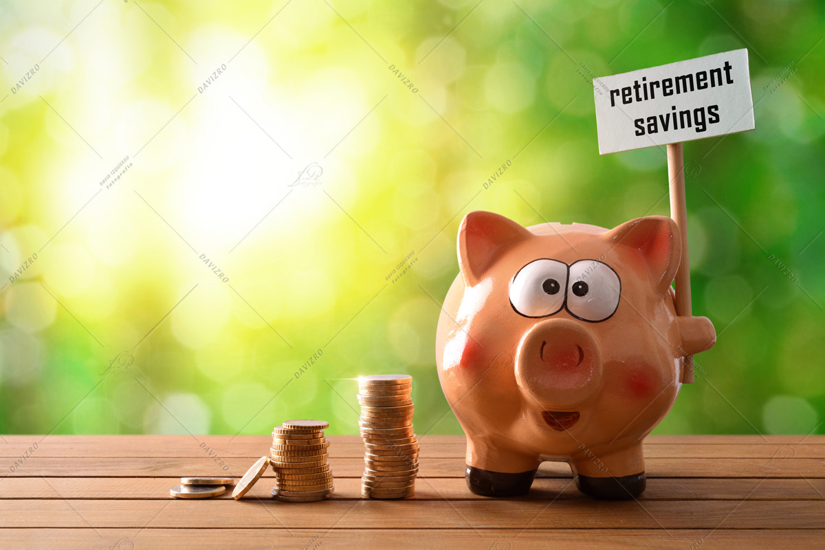 Piggy bank with billboard retirement savings on table nature bac