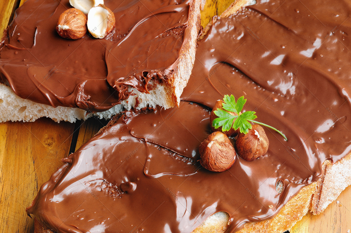 Tamron SP 24-70mm F2.8 Di VC USD sample photo. Bread with chocolate cream and hazelnuts on table closeup top photography