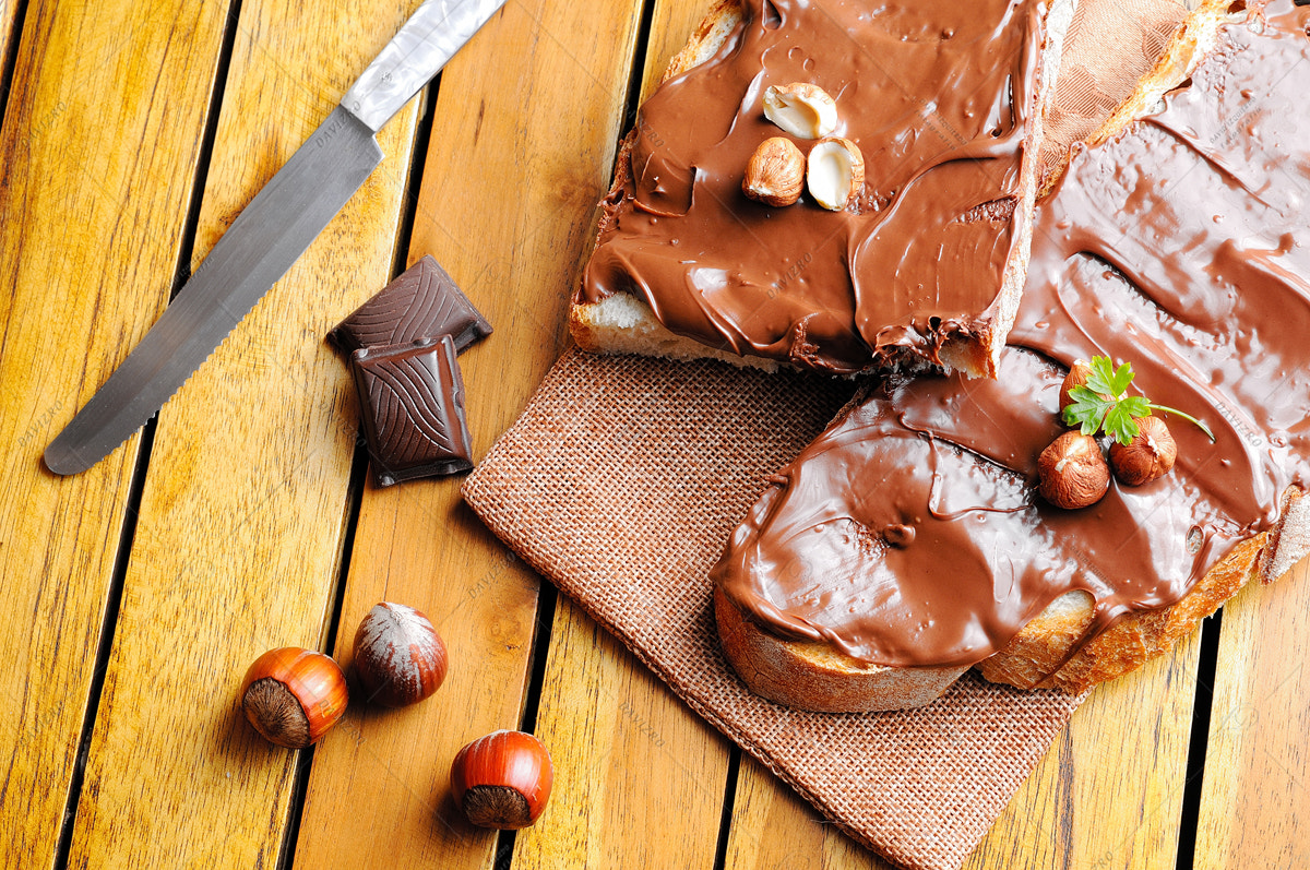 Tamron SP 24-70mm F2.8 Di VC USD sample photo. Bread with chocolate cream and hazelnuts on a table top photography