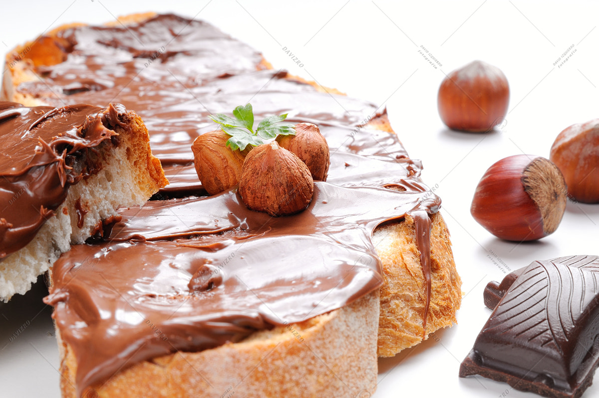 Nikon D300 sample photo. Two slices of bread with chocolate cream and hazelnuts closeup photography