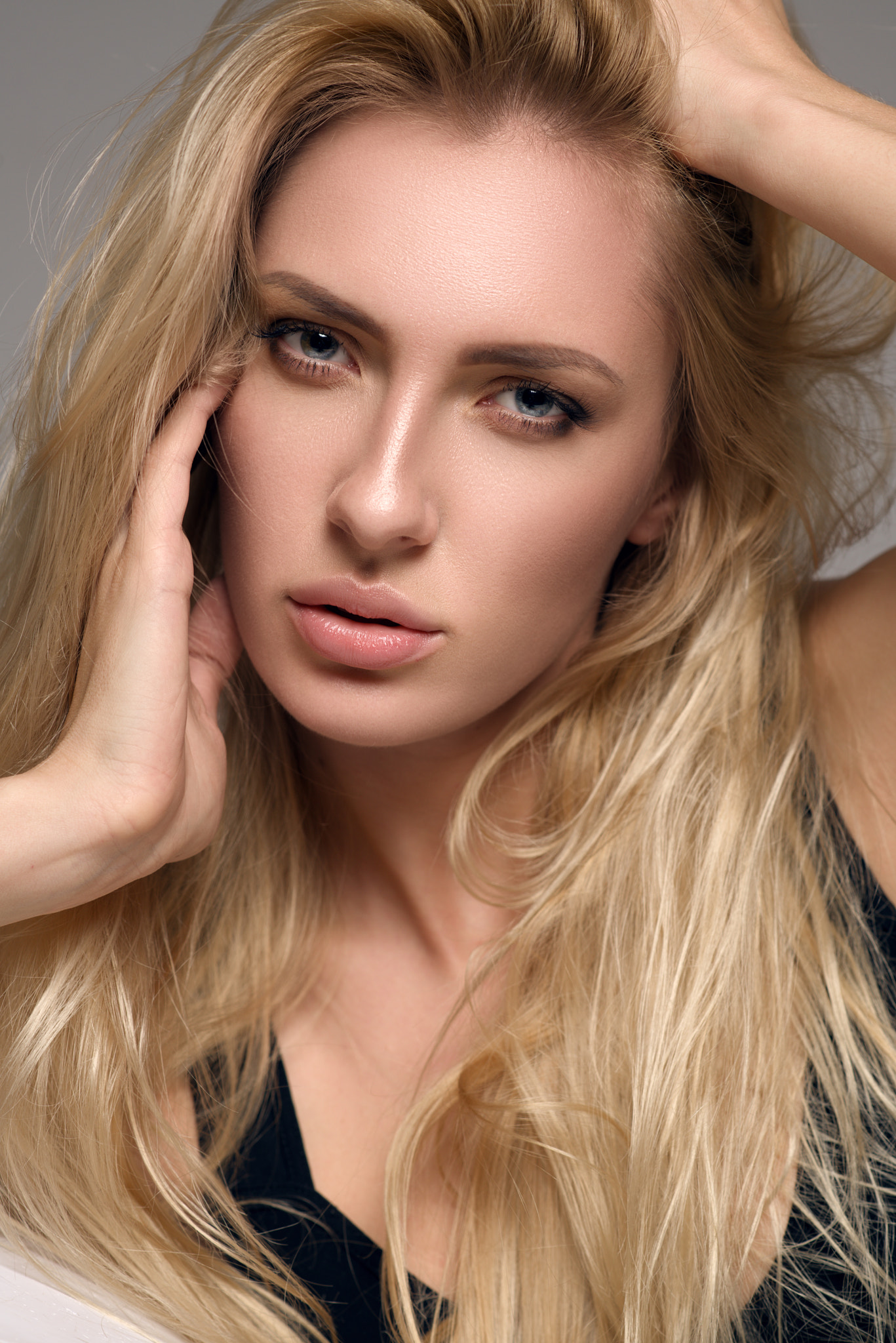 Close portrait of a young and beautiful girl in the studio with a healthy and clean skin and...