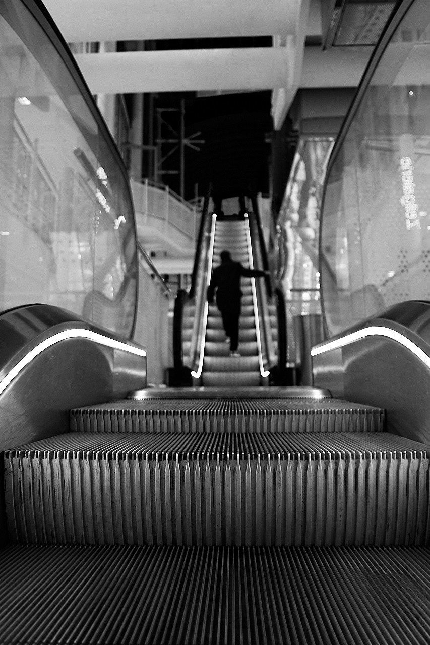 Sigma 19mm F2.8 EX DN sample photo. Man on an escalator photography