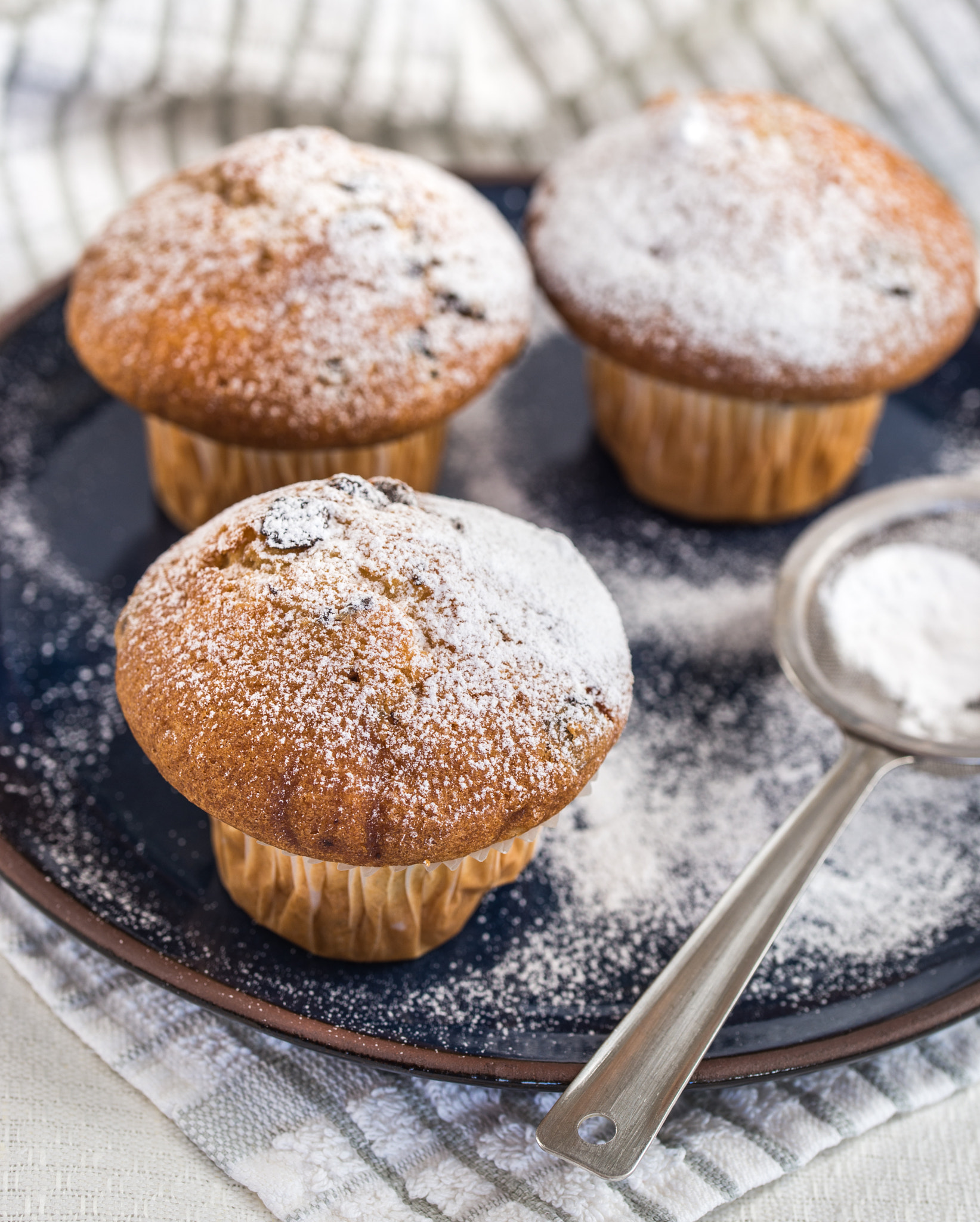 Nikon D610 + Tamron SP 90mm F2.8 Di VC USD 1:1 Macro (F004) sample photo. Muffins sprinkled by powdered sugar on blue plate and strainer. photography