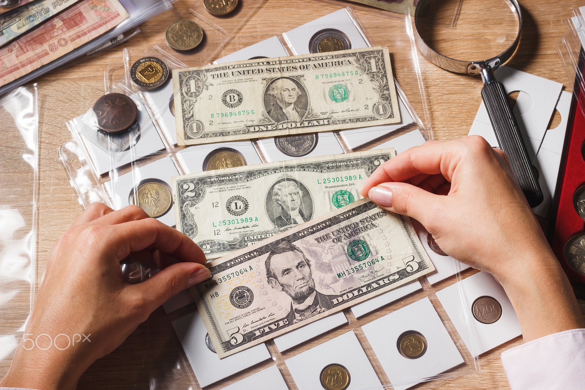 Woman holds a set of dollars in the pockets