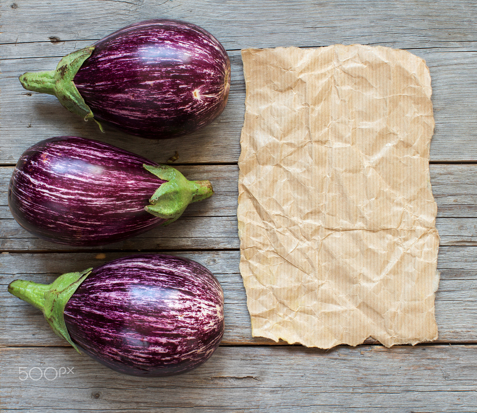 Canon EOS 650D (EOS Rebel T4i / EOS Kiss X6i) + Canon EF 50mm F1.2L USM sample photo. Fresh raw striped eggplants and craft paper o photography