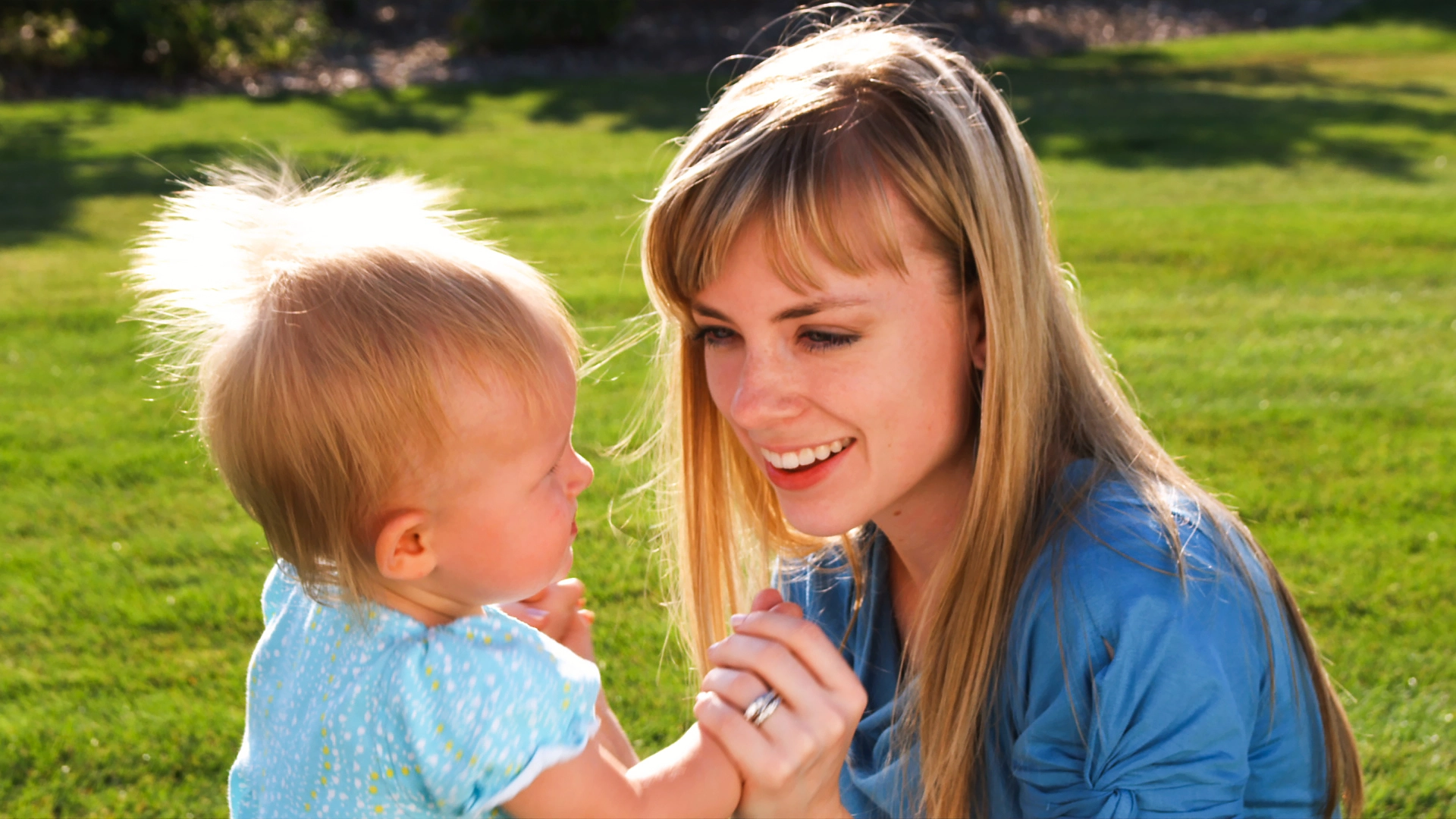 Young couple with their little girl in a garden in slow motion.