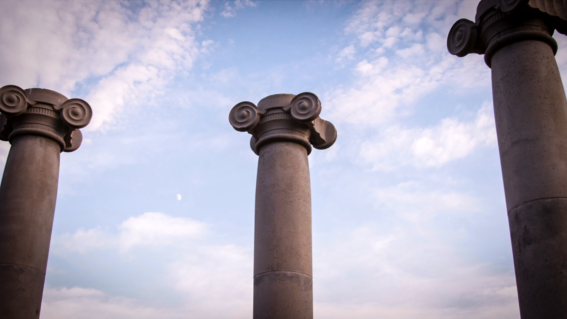 Low-angle slow pan of ionic columns