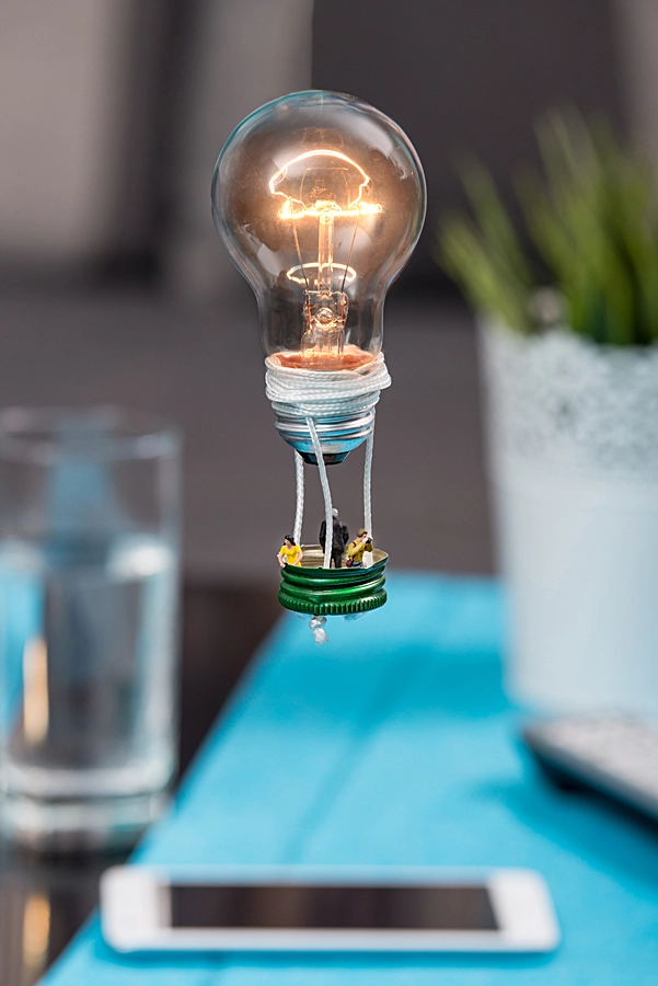 Nikon D610 sample photo. Tiny people in a balloon made from a light bulb. the concept of photography