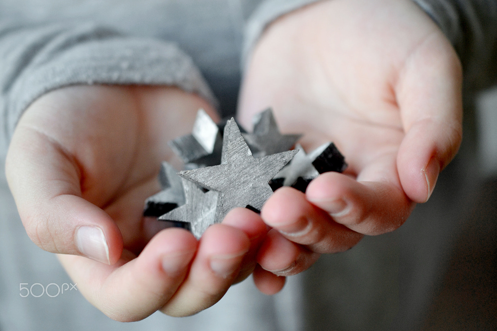 Nikon D3100 sample photo. Gray wooden stars in girls hands photography