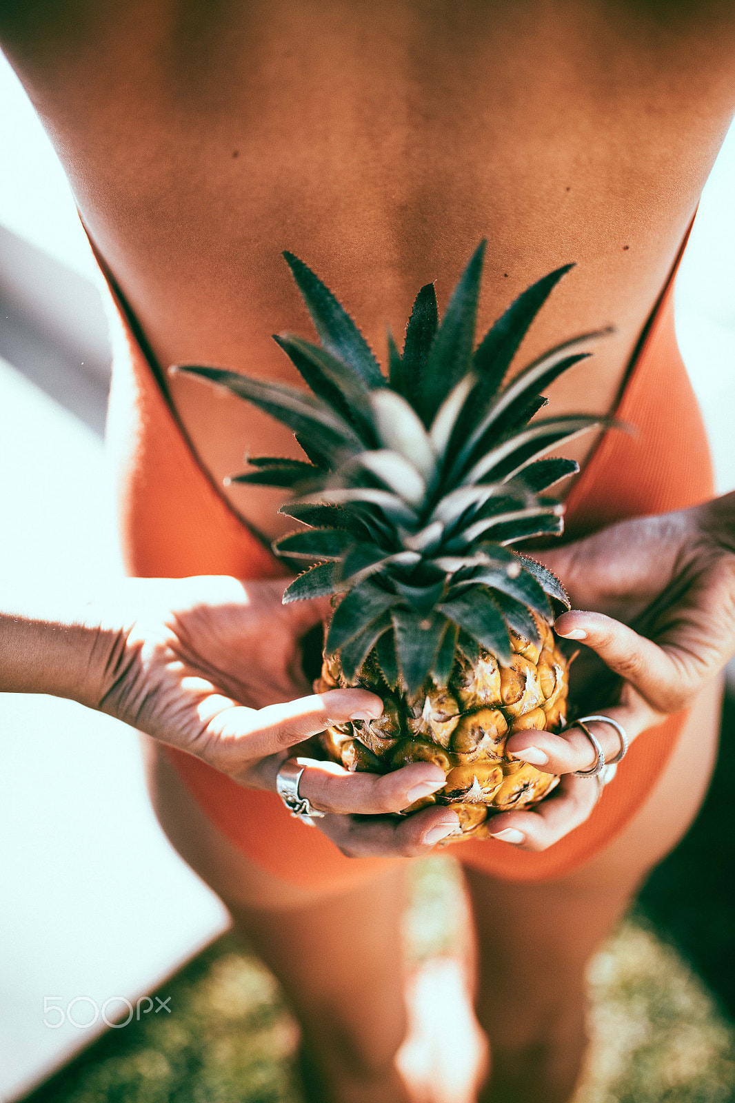Canon EOS 5DS + Sigma 35mm F1.4 DG HSM Art sample photo. Young women holding pineapple behind her back photography