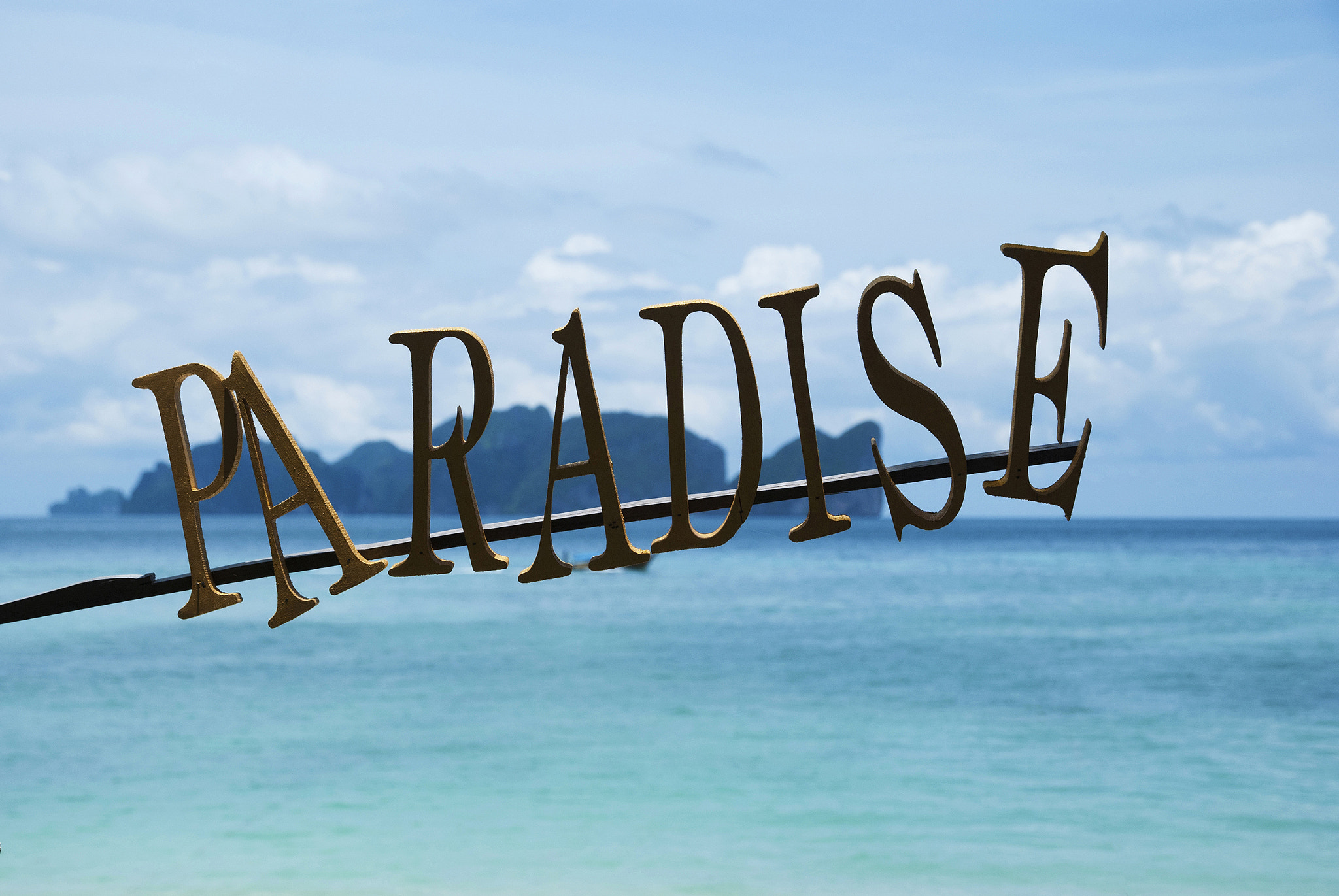 Nikon D80 sample photo. Paradise sign with a sea and islands on background photography