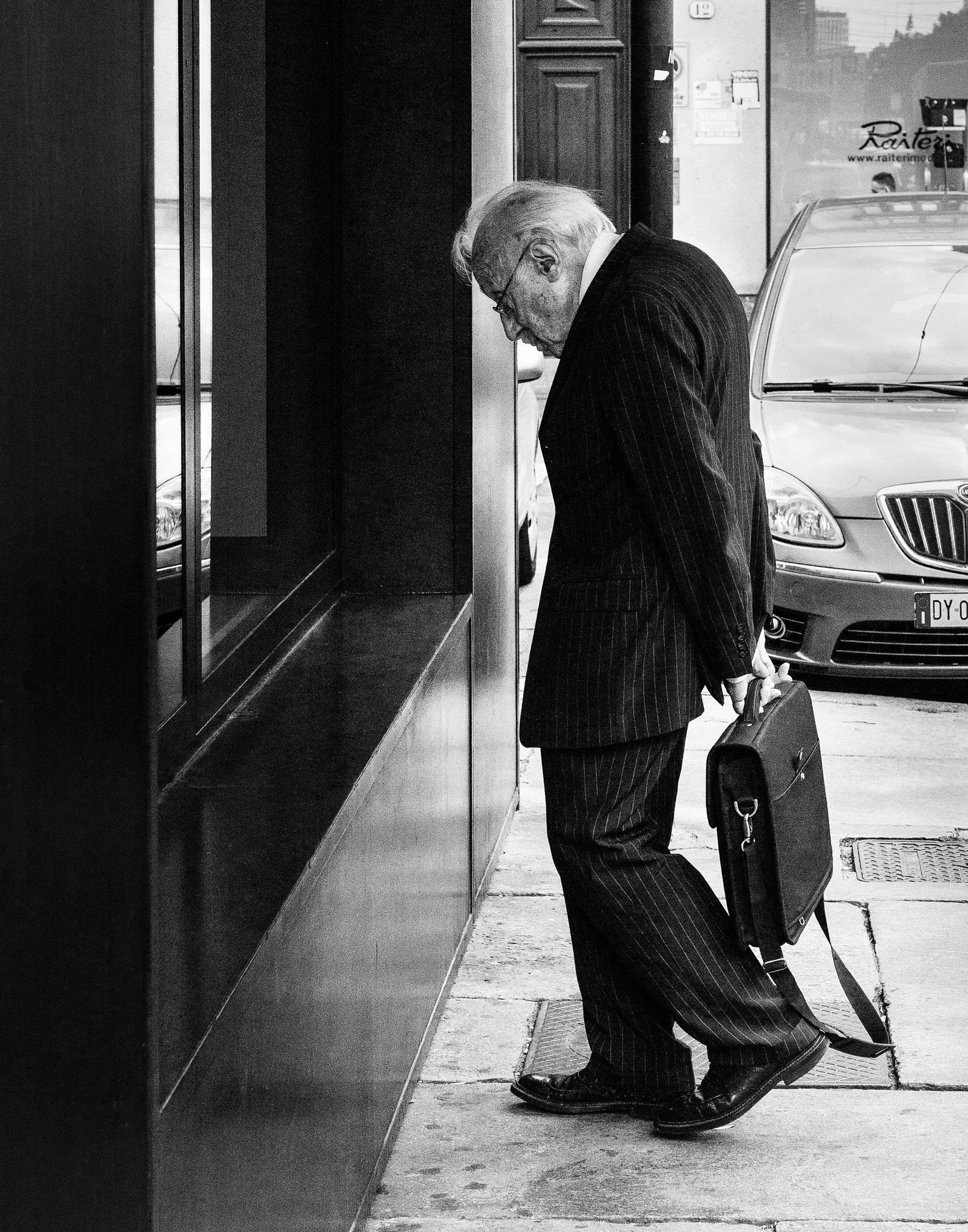 Sony a5100 + Sony E 35mm F1.8 OSS sample photo. Man contemplating an object in a store window, torino, italy photography