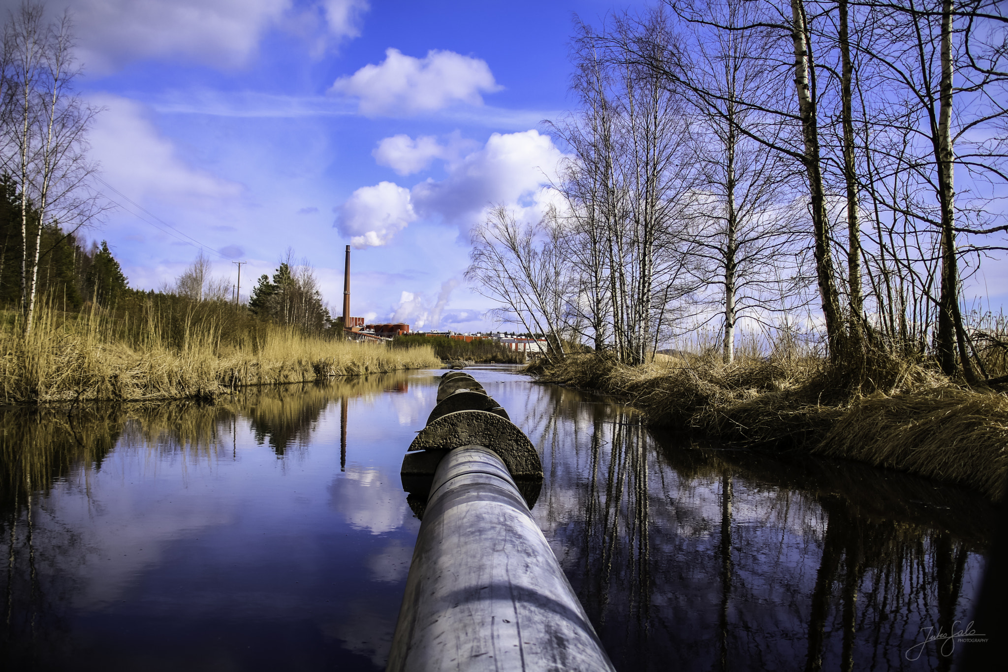 Canon EF 75-300mm F4.0-5.6 IS USM sample photo. Factory pipe above blue river. photography