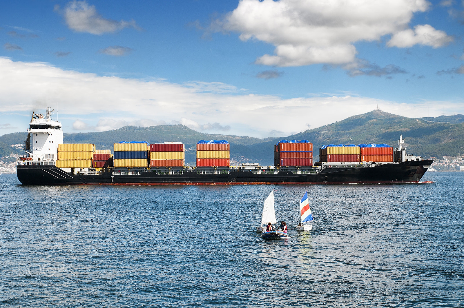 Tamron SP 24-70mm F2.8 Di VC USD sample photo. A container ship is sailing along the coast photography