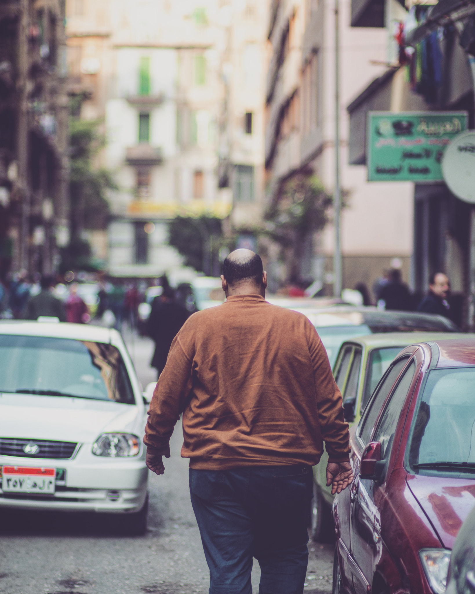 Nikon D7000 + Sigma 85mm F1.4 EX DG HSM sample photo. Man walking in downtown alley photography