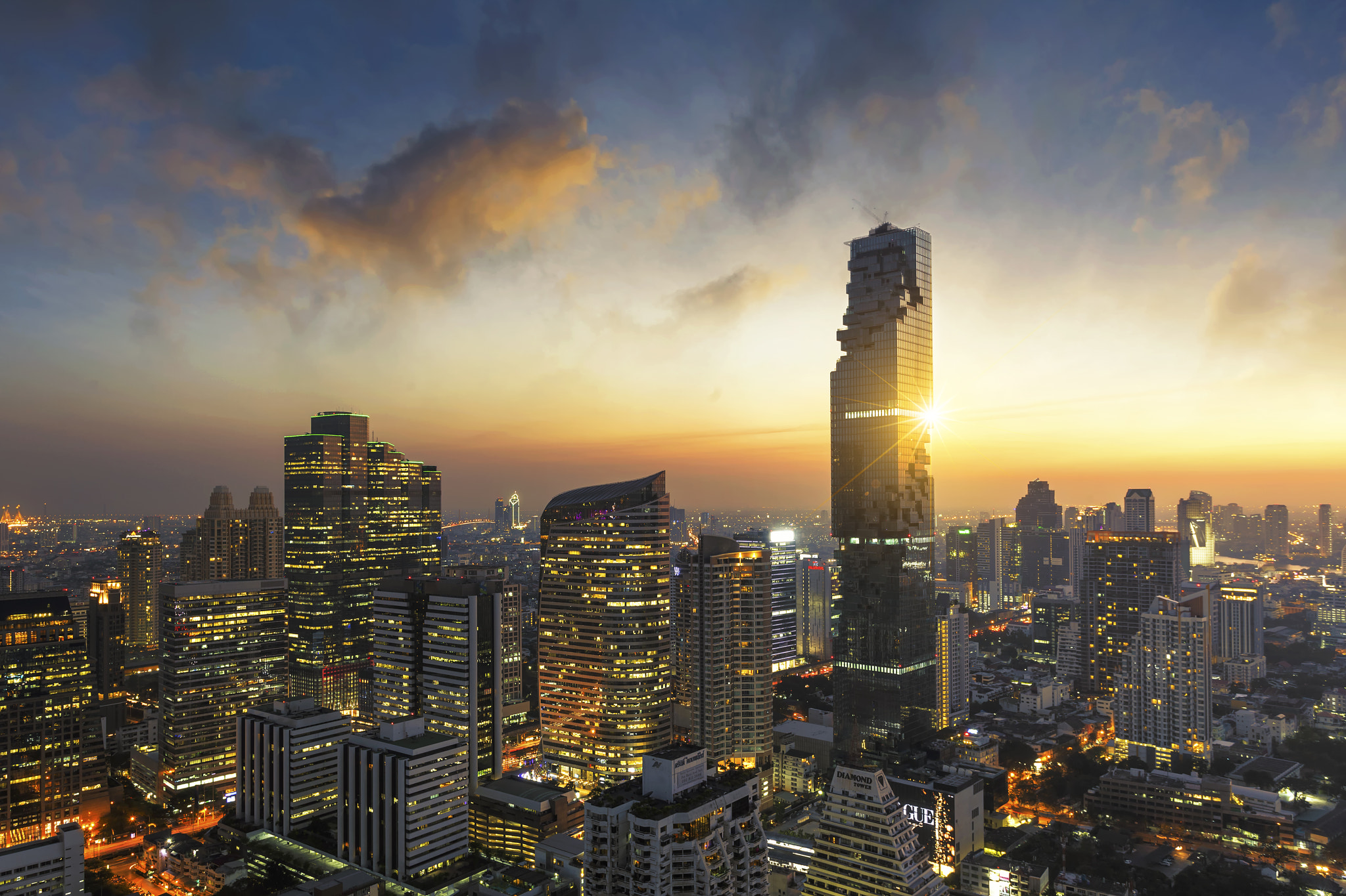 Aerial view of Bangkok modern office buildings, condominium in Bangkok city downtown with sunset...