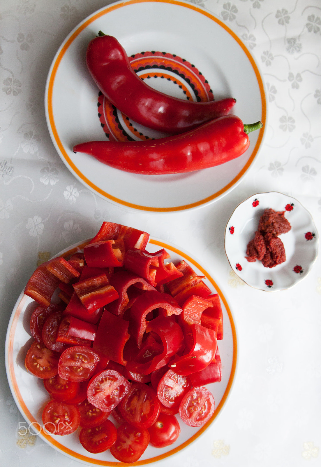 Canon EF 24-70mm F2.8L II USM sample photo. Red bell peppers on the table, cut and whole photography