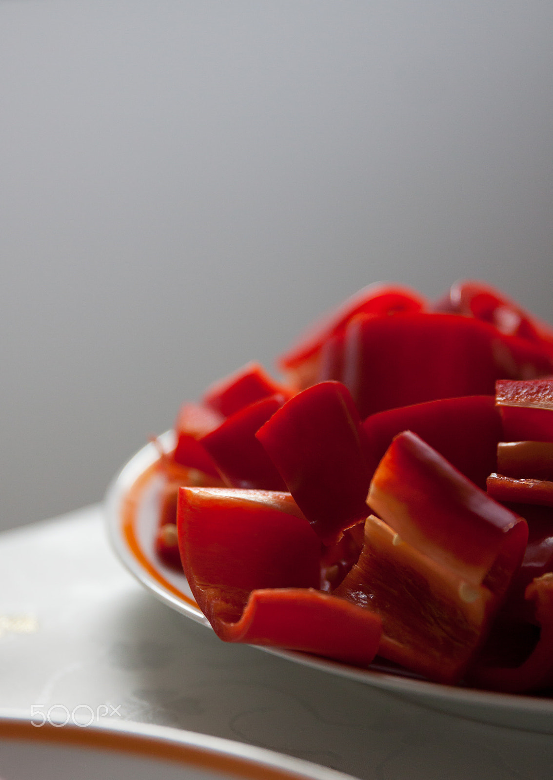 Canon EF 24-70mm F2.8L II USM sample photo. Red bell peppers on the table, cut and whole photography