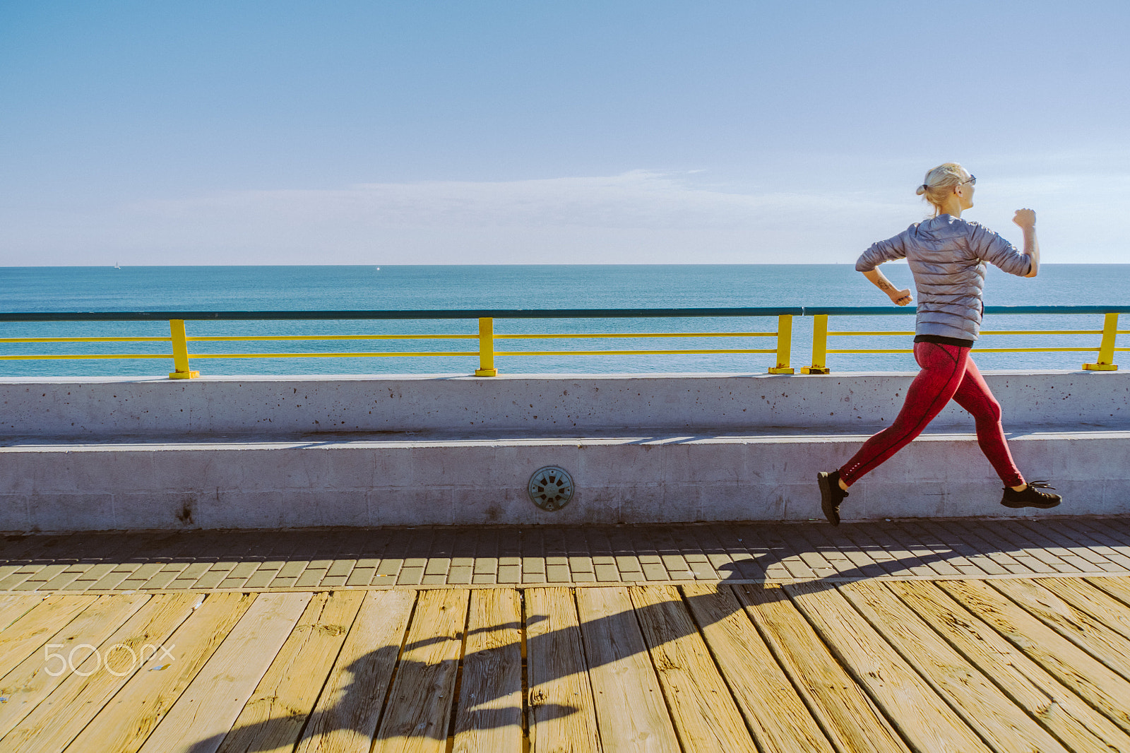 Sony E 18-200mm F3.5-6.3 OSS LE sample photo. Young woman running on the pierce photography