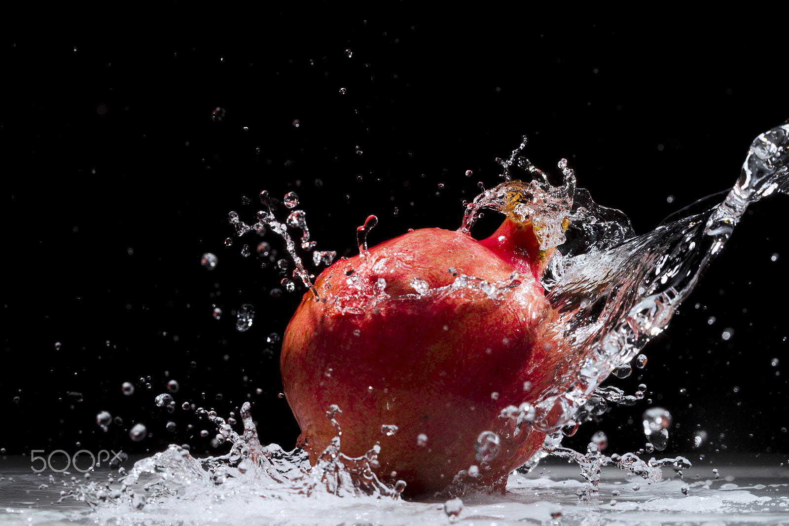 Canon EOS-1D Mark IV sample photo. Pomegranate splashing water photography