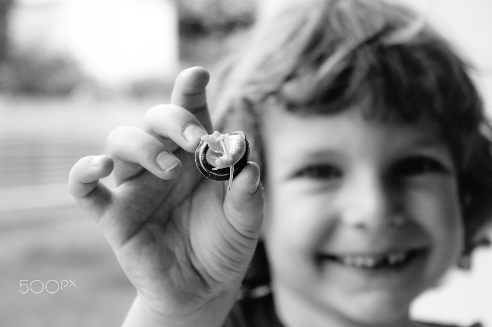 Canon EF-S 18-55mm F3.5-5.6 IS sample photo. A boy with a snail photography