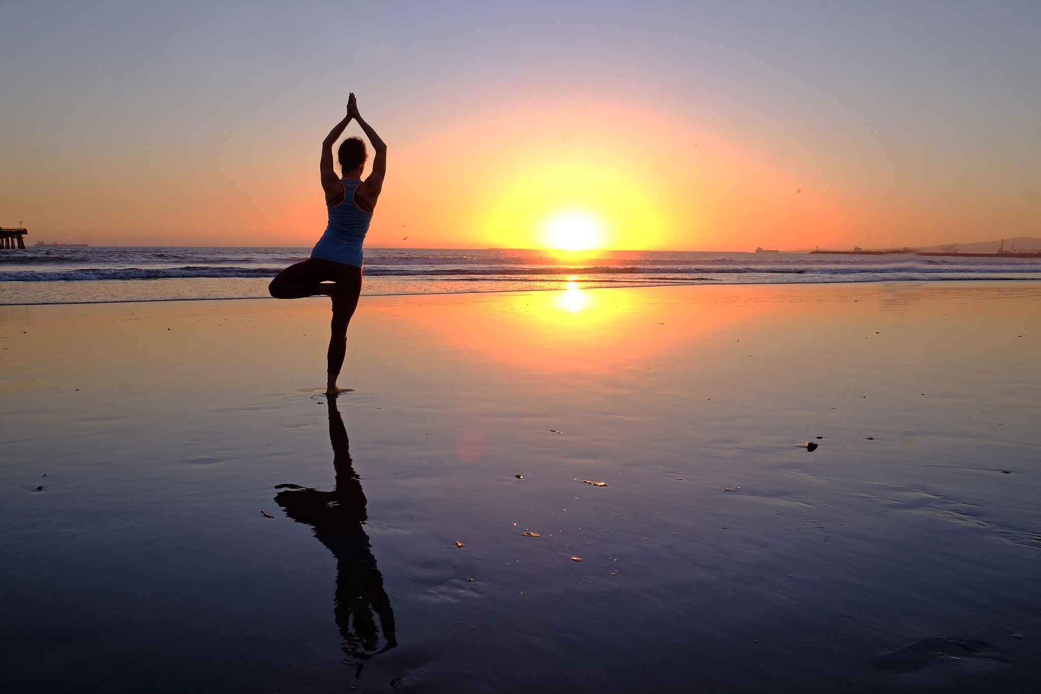 Fujifilm X-T1 sample photo. Woman practicing yoga on beach at sunset photography
