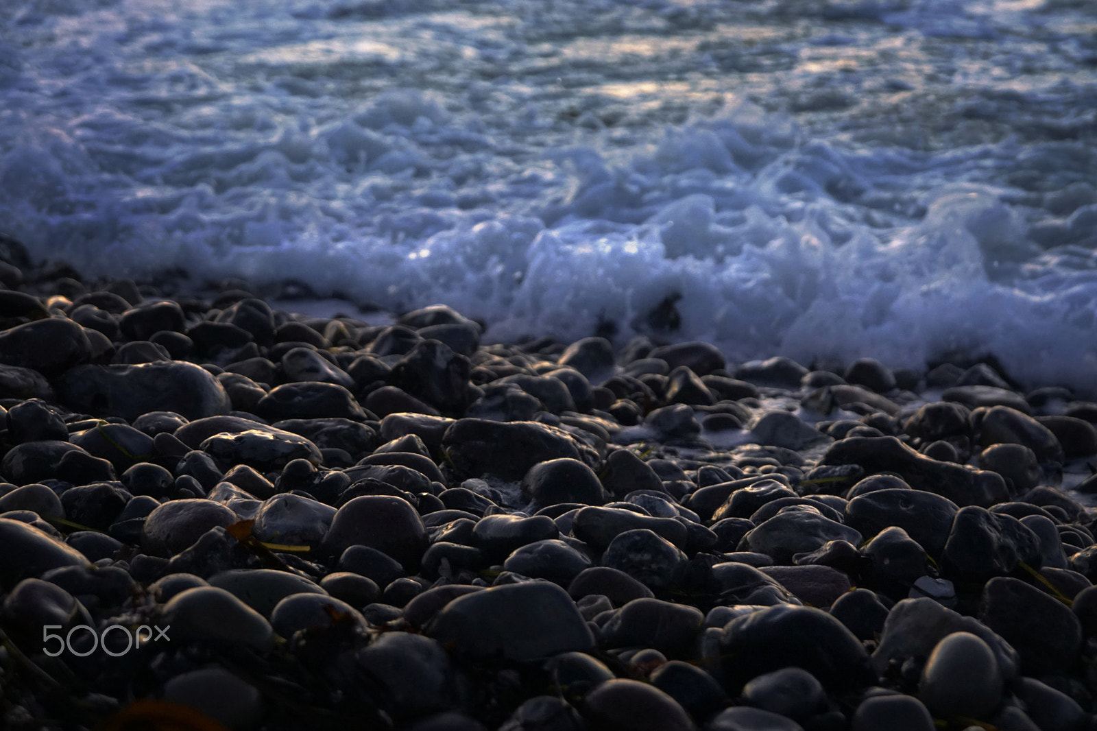 Sony ILCA-77M2 sample photo. Cold waves rolling over stones photography