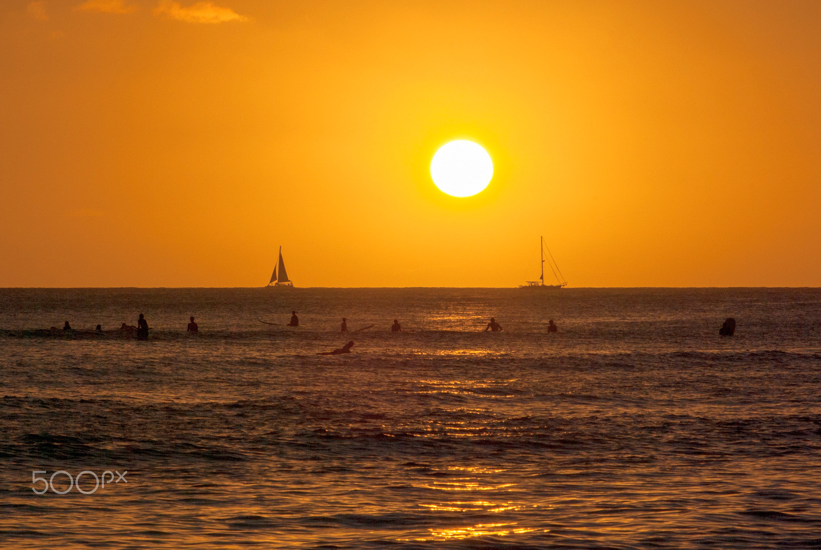 Pentax K10D sample photo. Surfers waiting a wave in sunset time photography