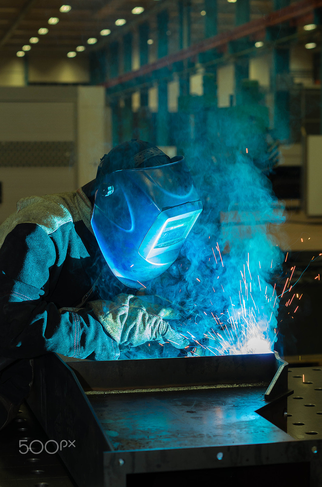 Pentax K-5 II sample photo. Welder welds metal parts in a protective suit photography