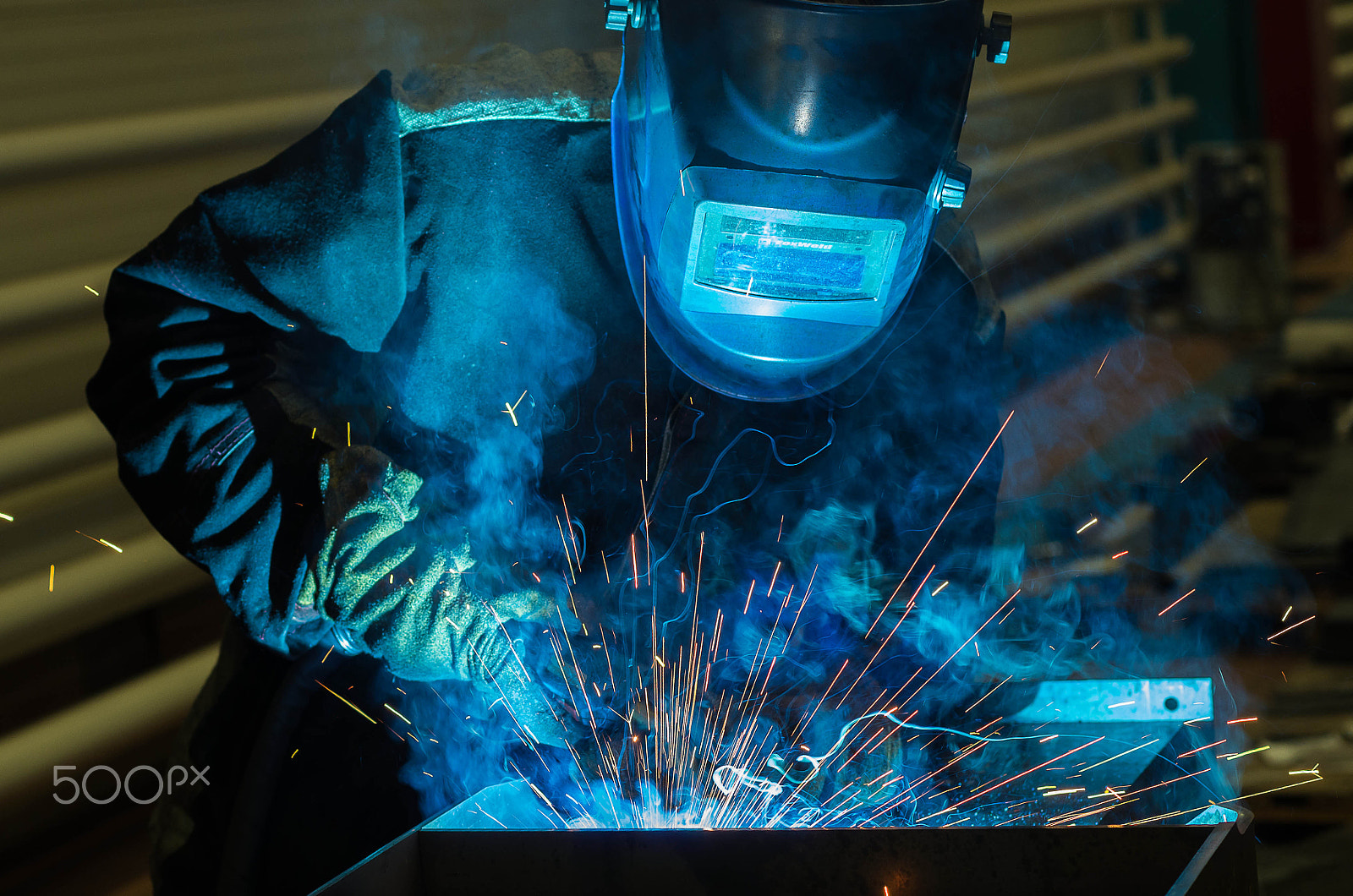 Pentax K-5 II + Pentax smc DA 50mm F1.8 sample photo. Welder welds metal parts in a protective suit photography