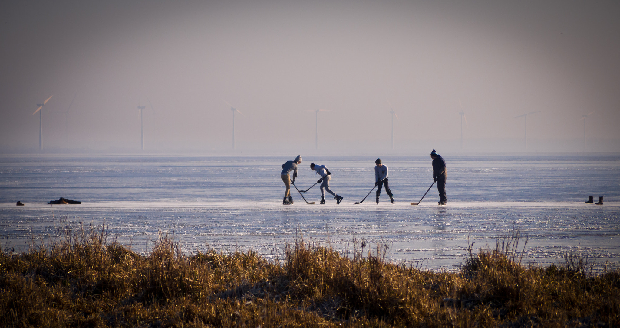 Olympus OM-D E-M10 sample photo. Boys playing ice hockey on the frozen eemmeer photography