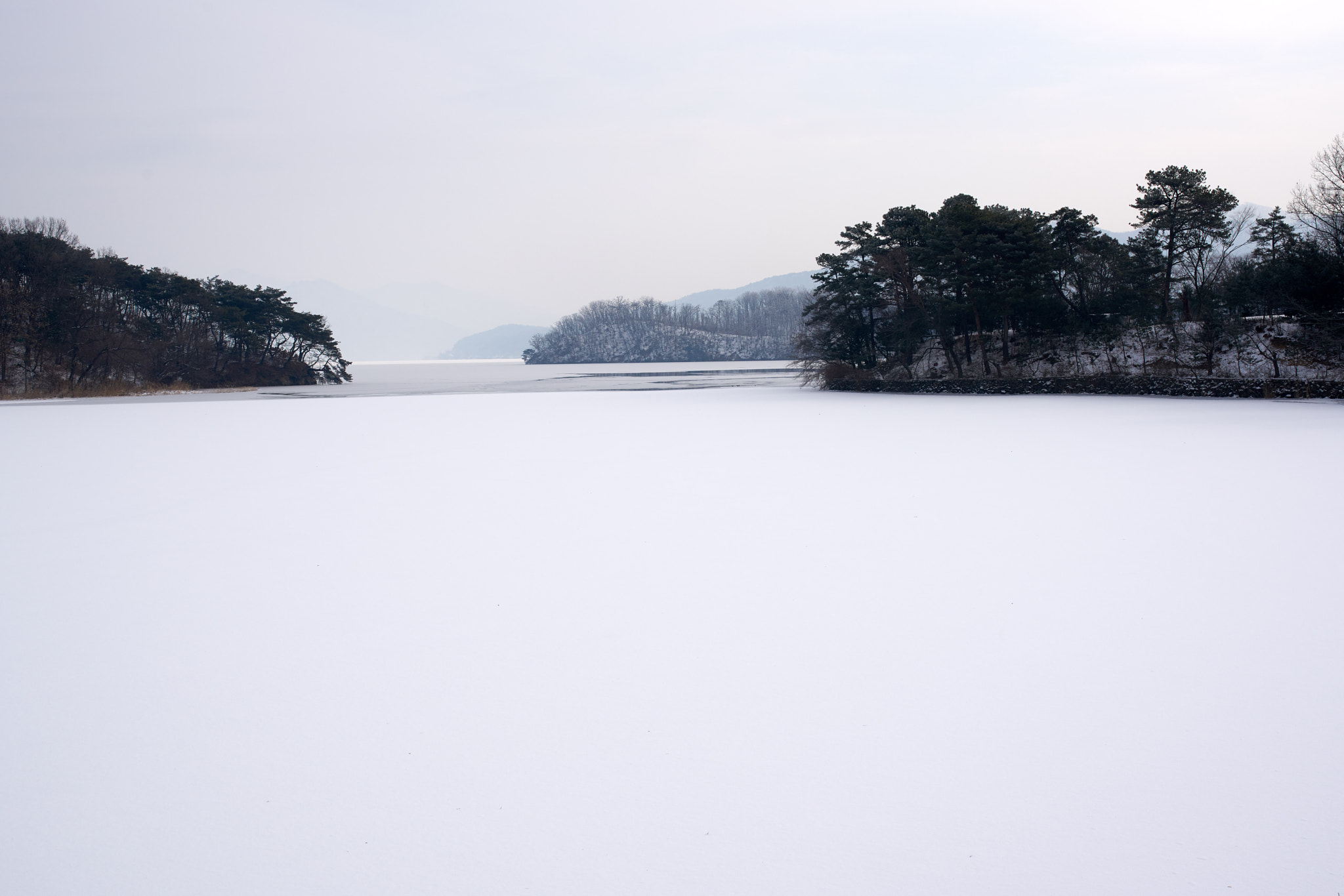 35mm F1.4 sample photo. Snow and river photography