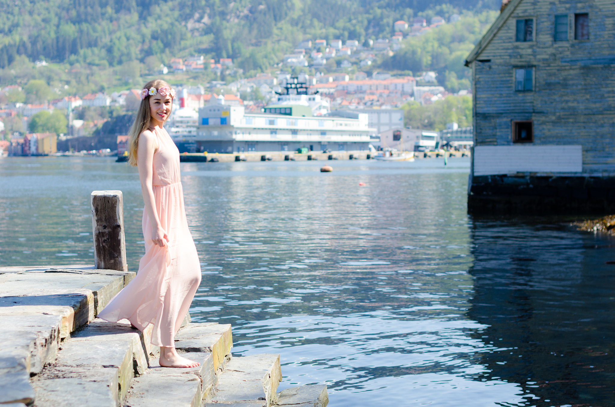 Nikon D7000 + Sigma 50mm F1.4 EX DG HSM sample photo. Female model in dress walking stairs towards water photography