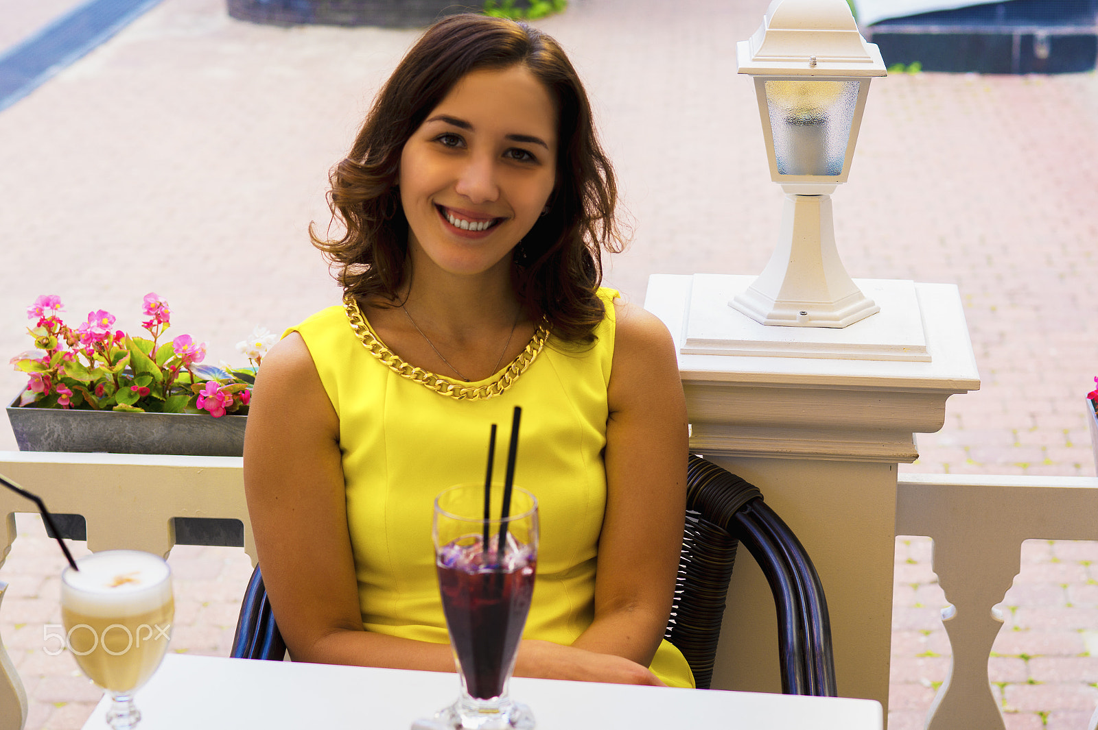 Sony SLT-A58 + Sony 50mm F1.4 sample photo. Beautiful girl in bright yellow dress sitting in summer cafe photography