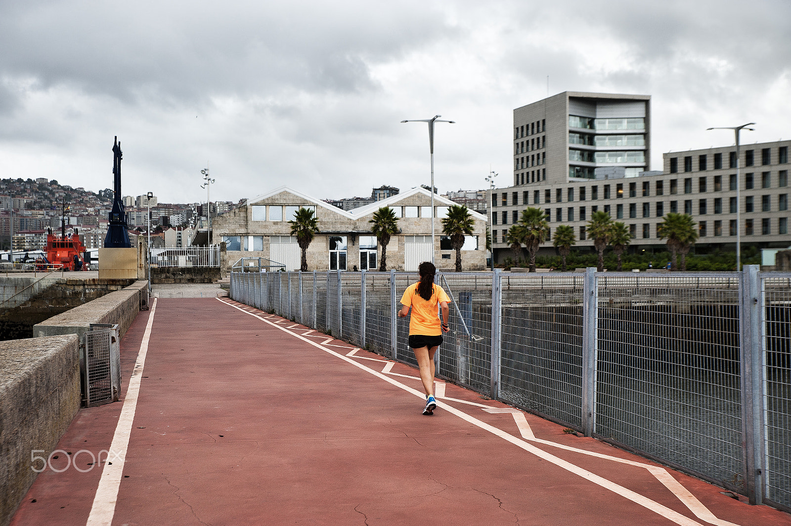 Nikon D700 sample photo. A woman does sport running in the city photography