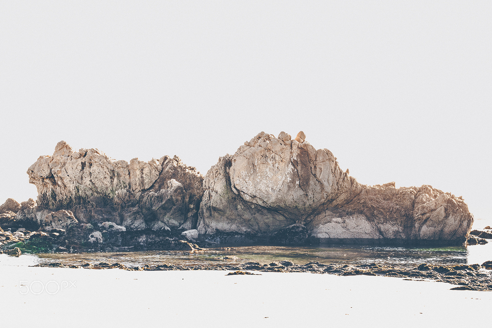 Sigma 30mm F1.4 EX DC HSM sample photo. Ocean rocks within negative space overexposed photography