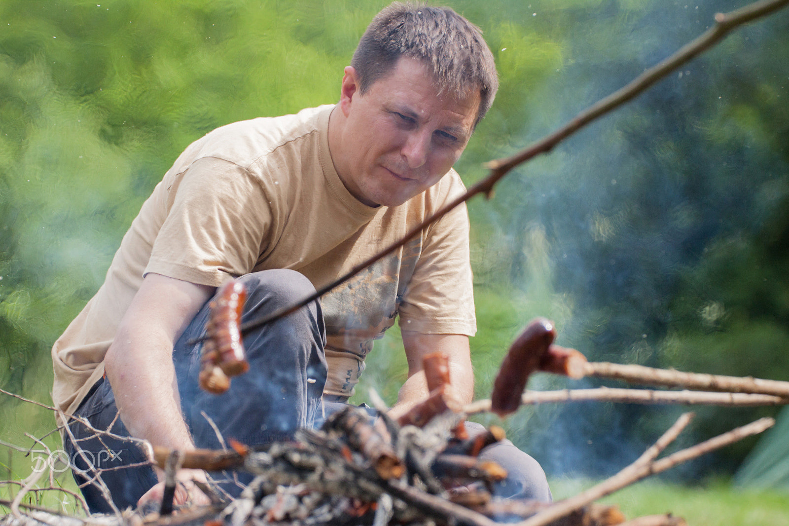 Canon EF 180mm F3.5L Macro USM sample photo. The man put the same wood to the fire photography