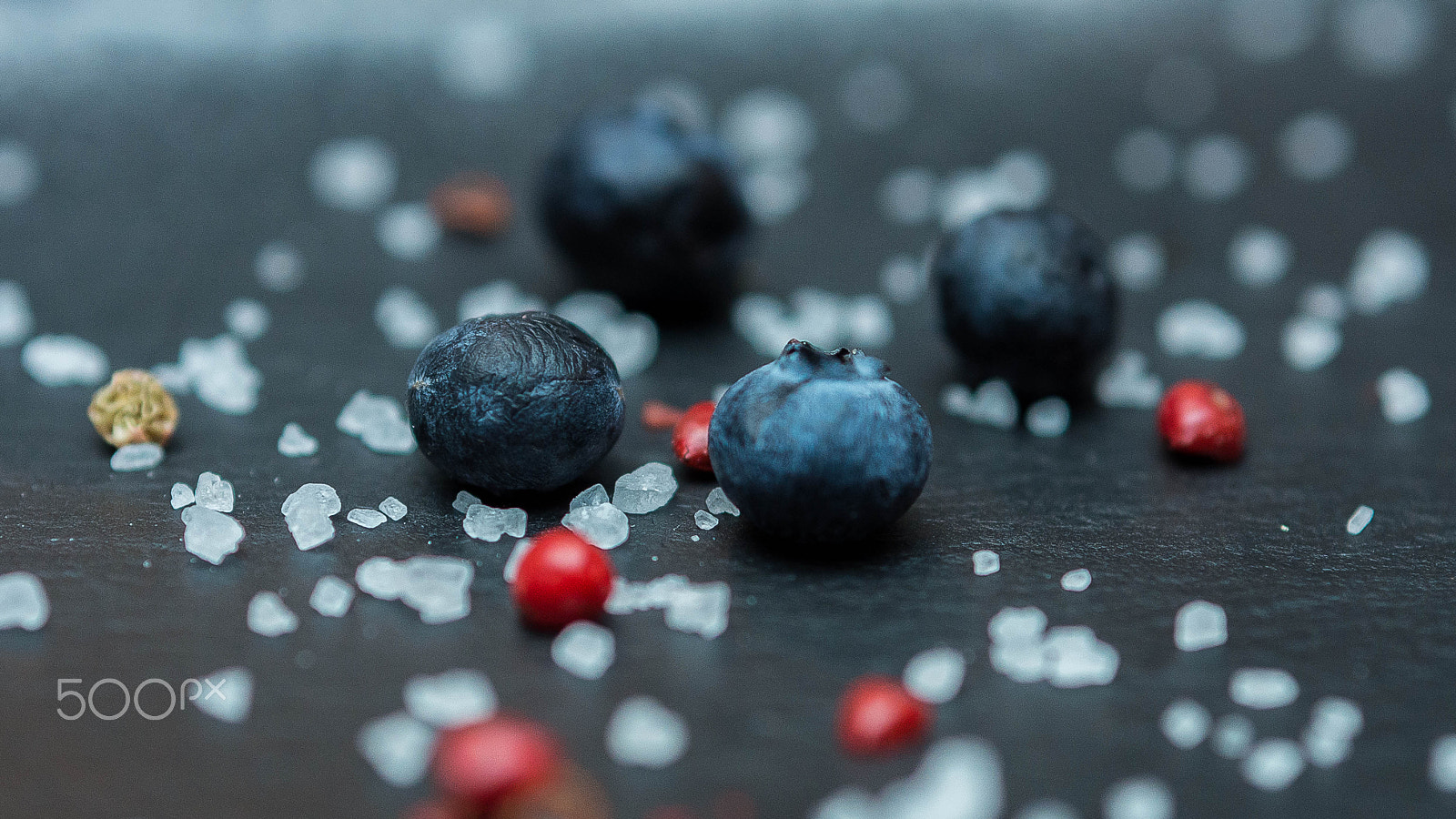 Pentax K-5 II sample photo. Blueberry berries with sugar granules close-up on a dark background photography