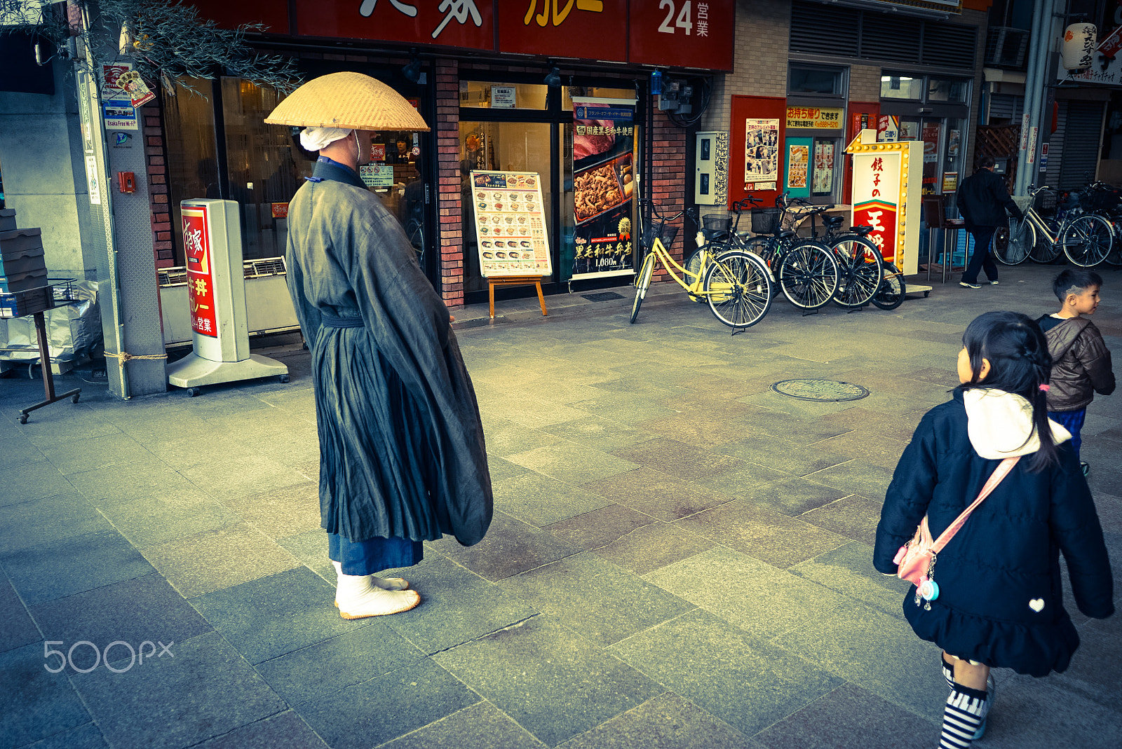Sony E 20mm F2.8 sample photo. A buddhist on the street photography