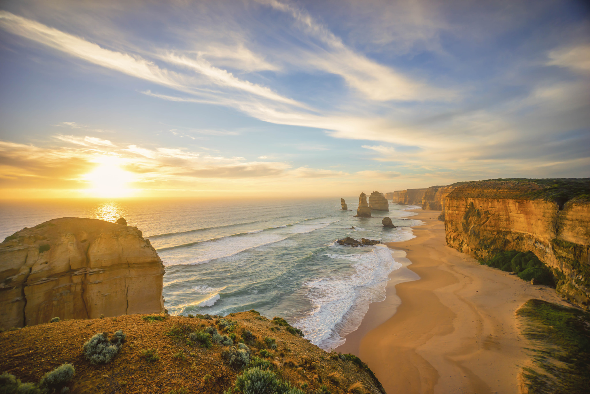 Sony a7R + Sony E 10-18mm F4 OSS sample photo. Dramatic sunset sky at unique rock formation along a coastline. photography